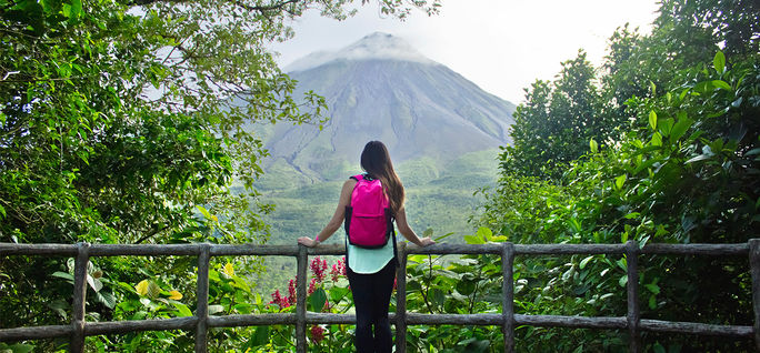Hiker looking out at the Arenal volcano in La Fortuna